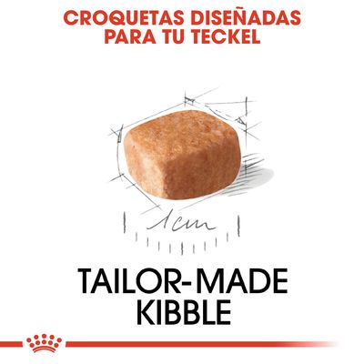 Texto: Croquetas diseñadas para tu teckel. Imagen de una croqueta con medida 1 cm. Texto en inglés: Tailor-made kibble.