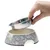 Hand lifts removable stainless steel bowl from grey feeding bowl with cat motifs.