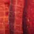 Close-up of red, dried meat strips with a textured surface.
