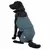 Dog wearing a blue and black coat with adjustable drawstrings and a visible badge, demonstrating fit and coverage of the garment.