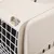 Close-up of a beige transport box with white grid and grey locking mechanism.