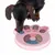 Dog playing with pink intelligence toy in paw shape, featuring movable elements and compartments for treats.
