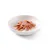 Morceaux de viande rose et dés orange dans une assiette blanche, présentés en gelée ou sauce claire. Aucun emballage ni marque visible.