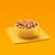 Bowl filled with chunks of wet pet food in gravy, placed on a folded yellow napkin against an orange background.