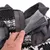 Close-up of a hand opening the hook-and-loop fastener on a fleece-lined garment, showing how to adjust or secure the closure.