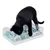 Black cat playing with interactive plastic feeding toy containing dry food in different compartments.