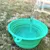 Green foldable silicone bowl, can be filled with water. Suitable for travel or outdoor activities.