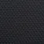 Czarna tkanina z widocznymi wypukłymi kropkami, prawdopodobnie powierzchnia antypoślizgowa. Materiał tekstylny z regularnym wzorem kropek.
