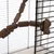 Échelle articulée en bois fixée à la grille d'une cage, composée de segments cylindriques et rectangulaires reliés entre eux.