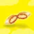 Close-up of a single filled pet treat with brown outer layer and light cream filling, shown against a yellow background. No visible branding or text.