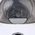 Instructions for use: Press the button to open the lid. Symbol shows a hand and lid movement.