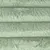 Detailansicht eines flauschigen, hellgrünen Stoffmaterials mit horizontalen Nähten.