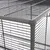 Close-up view of an enclosure with metal mesh walls and sturdy plastic corner connectors.