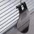 Black plastic clip for attaching to metal grids, suitable for cages or enclosures.