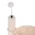 Beige scratching post with plush ball on a metal spring, attached to a padded post.