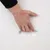 Hand reaching into an integrated handle of a white container, showing easy handling and transport option.