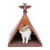Chat blanc et roux dans une tente en carton décorée de motifs colorés, sol en carton ondulé, ornement en forme de totem sur le dessus.