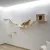 Wall-mounted wooden climbing set with hammock, bridge and cave. Cat demonstrates use of the elements.