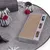 Play mat with scratching surface made of cardboard, two play balls and several fabric elements with red pompoms for interactive play.