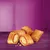 Five crispy, filled snacks with a light filling on a purple background, some crumbs visible.