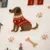 Illustrazione di un cane marrone con maglione rosso, impronte di zampe, ossa e case su sfondo color crema. Illustrazione di un cane marrone con maglione rosso, impronte di zampe, ossa e case su sfondo color crema.