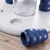 Close-up of a white game board with blue plastic elements and a transparent container. Suitable for interactive play or training.