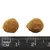 Close-up of two brown kibbles with size comparison using a ruler in millimetres.