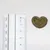 Heart-shaped treat next to a ruler with centimetre scale for size determination.