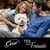 Cesar. Teil deine Freude. Werbung mit einem weissen Hund und zwei Personen im Hintergrund.