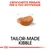 Testo: Crocchette pensate per il tuo Rottweiler. Immagine di una crocchetta. Testo in inglese: Tailor-made kibble.
