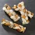 Braided dog chews made from fish skin and leather strips, three pieces on a dark background.