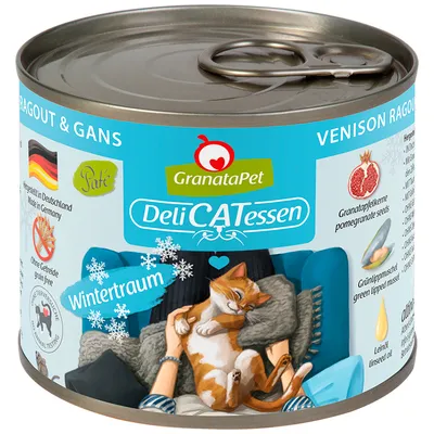 Lata de comida para gatos GranataPet DeliCATessen Wintertraum, paté sin cereales, con semillas de granada y aceite de linaza. Etiqueta en alemán e inglés, ilustración de gato naranja.