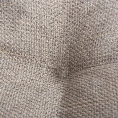 Dettaglio tessuto intrecciato beige, materiale in tessuto visibile da vicino.