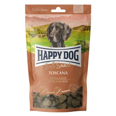 Happy Dog Soft Snack Toscana mit Ente und Lachs. Made in Germany, glutenfrei, ohne Zuckerzusatz, fettarm mit 6,5% Fett. Verpackung zeigt Hund vor toskanischer Landschaft.