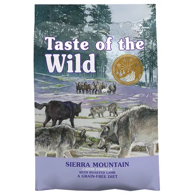 Taste of the Wild Sierra Mountain Canine Formula with Roasted Lamb, a grain-free diet. Purple bag with wolves and sheep illustration, gold seal visible.