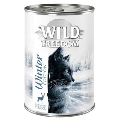 Conservă Wild Freedom Winter Edition, imagine cu pisică, text vizibil: Chicken with Venison. Ambalaj alb cu peisaj de iarnă.