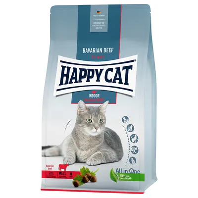 Pienso para gatos Happy Cat Bavarian Beef Indoor, 1+ años. Imagen de gato gris en el envase. Texto visible: All in One, Natural Life Concept, 86% proteína animal, bavarian beef.