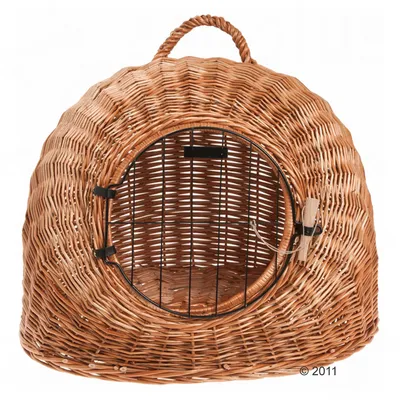 Wicker pet carrier with a round metal door and handle on top, suitable for transporting small animals. Door is secured with a latch.