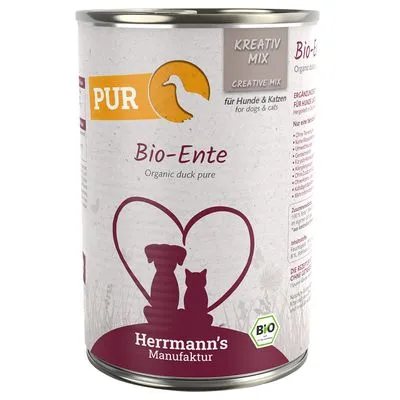 Blik Herrmann's Manufaktur Bio-Ente, PUR Kreativ Mix, voor honden en katten. Tekst: Organic duck pure, Bio-certificaat, afbeelding hond en kat in hartvorm.