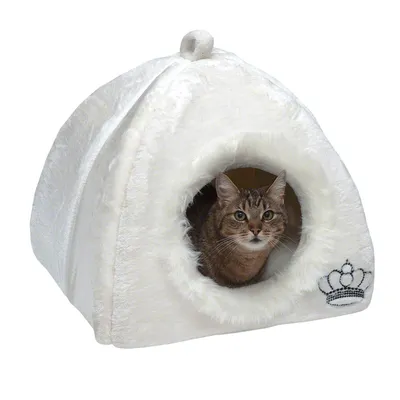 White cat house with round entrance, faux fur design and embroidered crown on the side. Cat sitting inside the house.