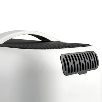 Transport box with white plastic housing, black ventilation grille and ergonomic carrying handle.