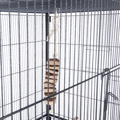 Jouet suspendu en bois et corde à l’intérieur d’une cage métallique pour oiseaux ou petits animaux, accroché par un crochet en métal.