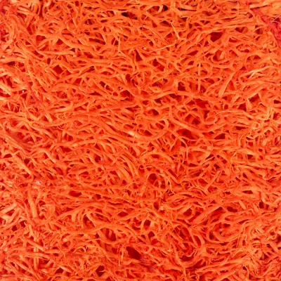 Krupan prikaz narančastih, vlaknastih materijalnih struktura. Nema dodatnih vidljivih informacija.