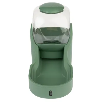 Green Tiaki food and water dispenser with transparent container and drip tray.