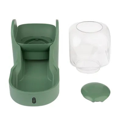 Green feeder with transparent container and removable lid. Tiaki brand visible on the front.