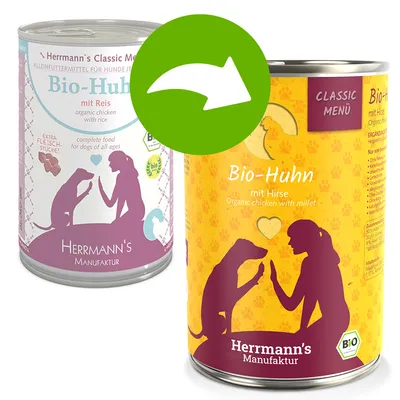 Změna obalu konzervy Herrmann's Manufaktur Bio-Huhn: původní s textem 'mit Reis', nový s textem 'mit Hirse'. Oba s motivem ženy a psa, nápisy v němčině i angličtině.