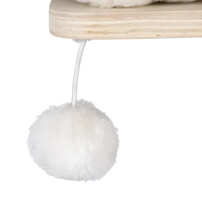 White plush ball on a string, attached to a wooden board.
