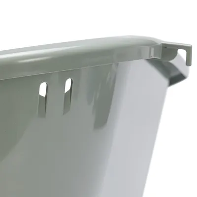 Close-up view of a green plastic container with hooks and slots for attachment.