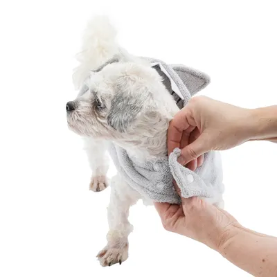 Dog wrapped in a grey towel with press studs, shows product application.