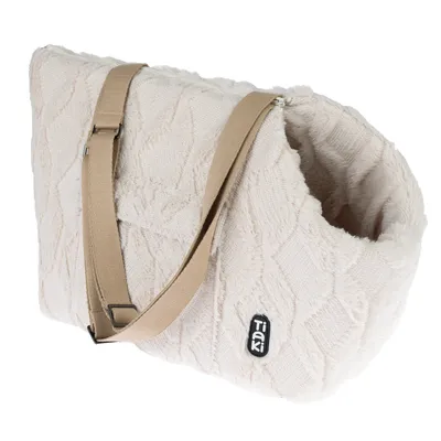 Sac de transport en tissu beige avec bandoulière réglable et étiquette visible Tiaki sur le côté.